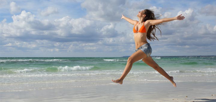 woman-jumping-on-beach