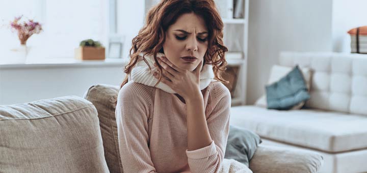sore-throat-woman-on-couch
