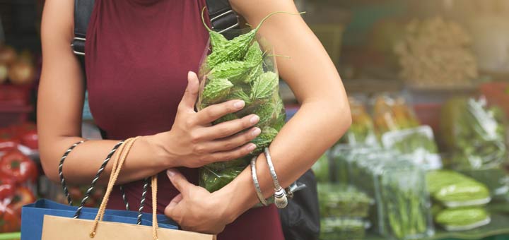 woman-with-bag-of-bitter-melon