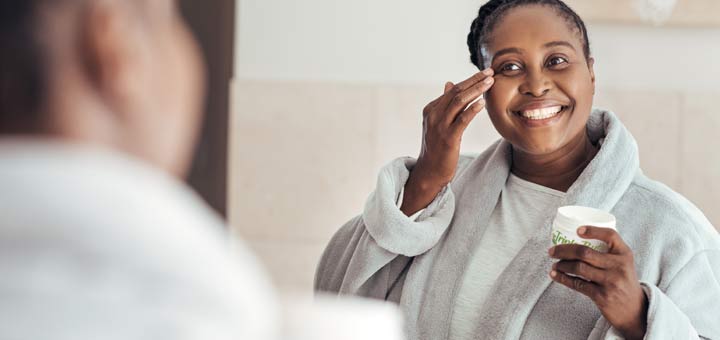 black-woman-moisturizing-face