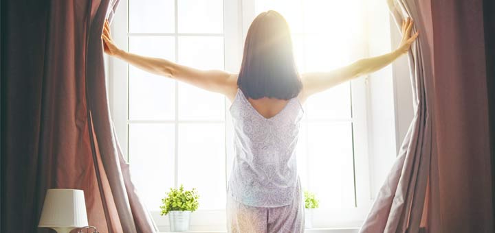 morning-woman-opening-curtains