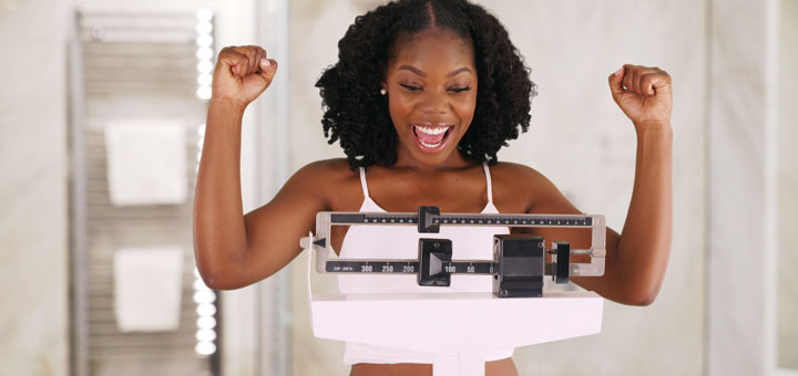 excited-black-woman-on-scale