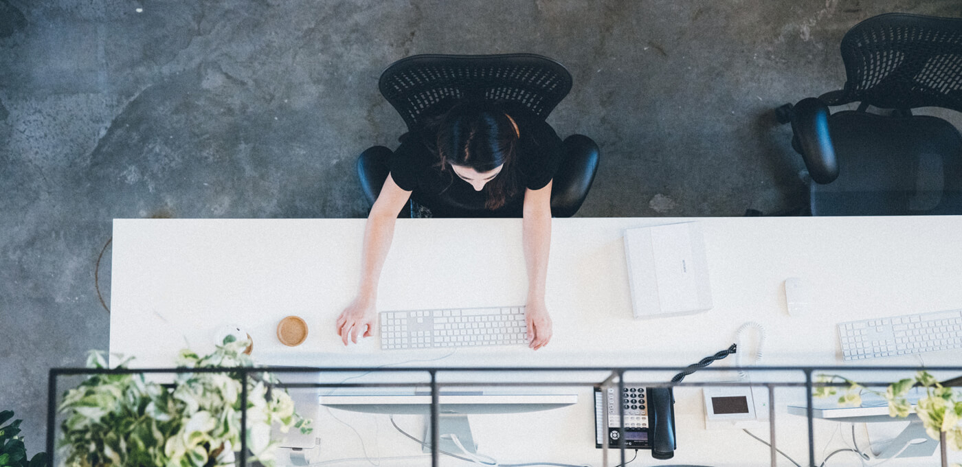 Woman working on computer at Instrument's office
