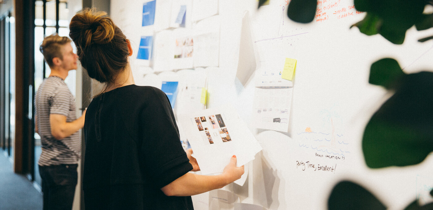 Man and woman collaborating at whiteboard