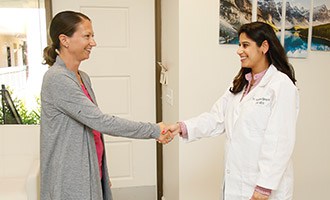 Doctor greeting patient in the front lobby