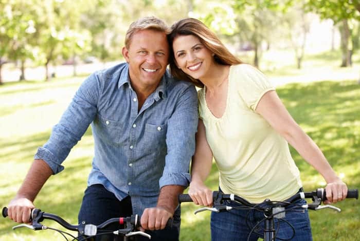 Happy middle-aged couple on bikes