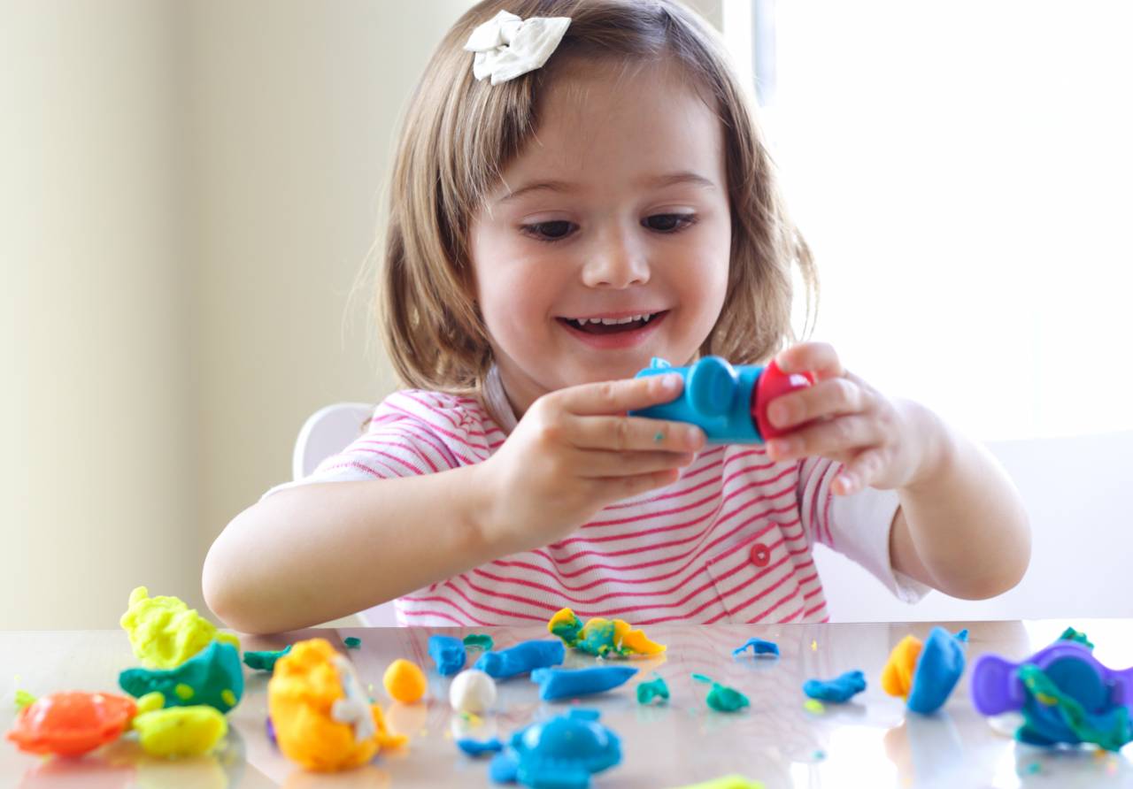 A child playing with Play-Doh for the Week of the Young Child 2020: Artsy Thursday