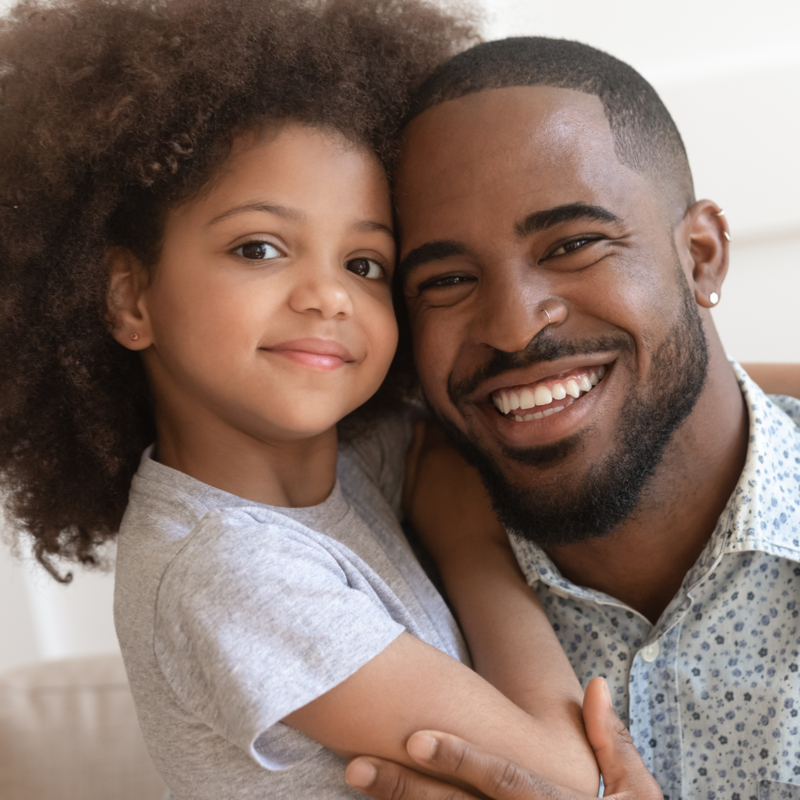 Father and daughter smiling