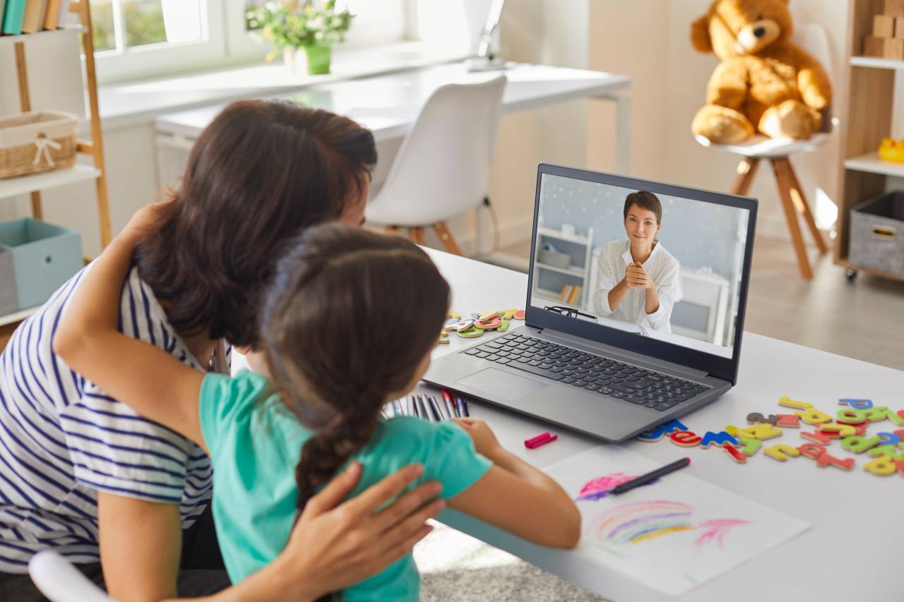 Building Social Skills in a Virtual World Contra Costa County parent and child attending a virtual child care consultation on a laptop.