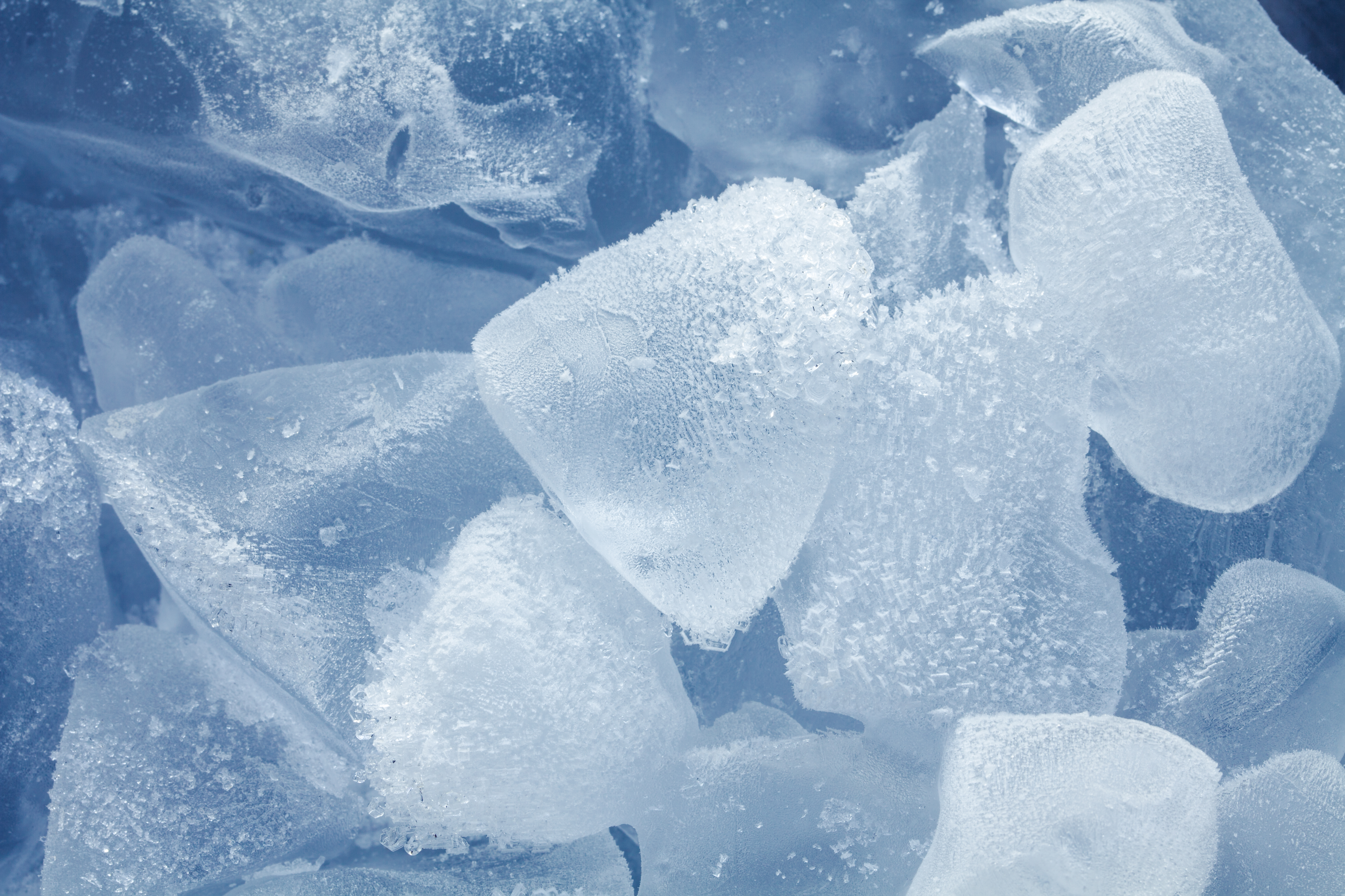 Melting Ice cubes with water drops on a table. Clear ice in cube shape.  Frozen water.