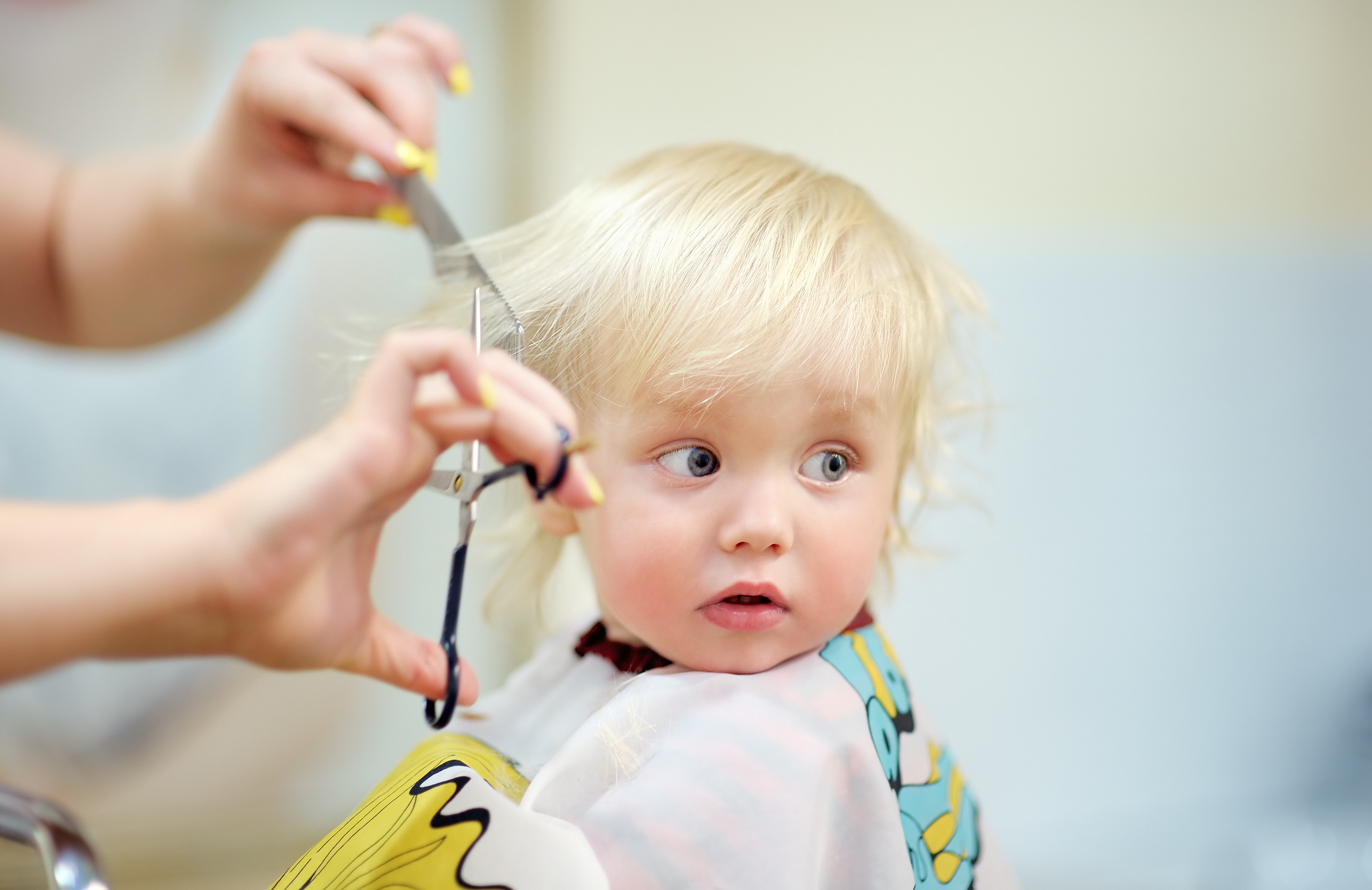 cutting baby hair with scissors