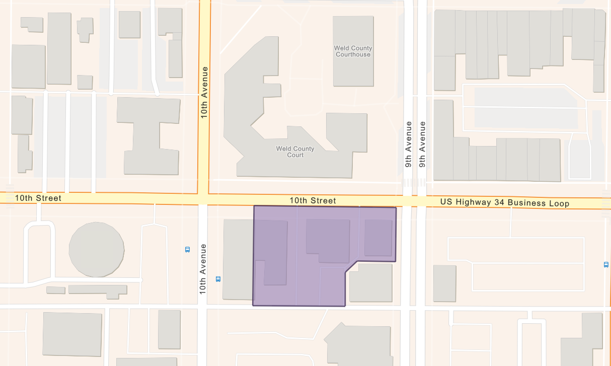 Aerial map of downtown Greeley showing a highlighted construction zone on 10th Street and 9th Avenue. Sidewalk impacts are shown along the north edge of the block. Adjacent streets remain open to traffic, with construction activity contained within the fenced area.