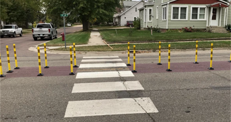 A pedestrian and bicycle crossing protected by a median island.