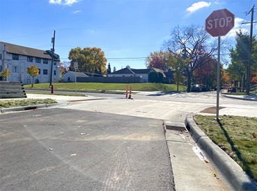A raised crosswalk with a stop sign next to it.