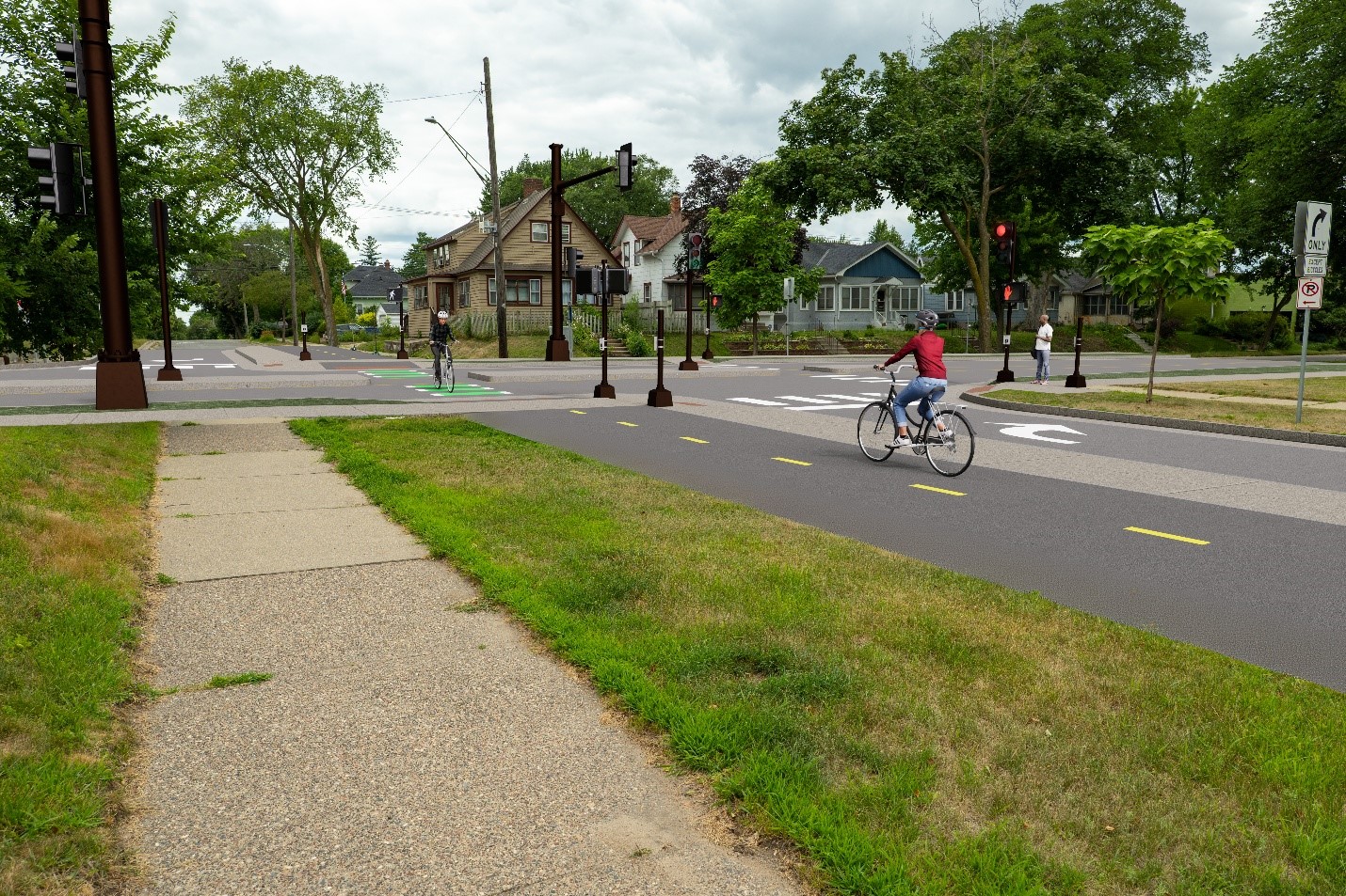 This rendering shows the intersection of Cedar Avenue and 40th Street with a traditional traffic signal at a reduced access intersection. It features a two-way bike path on the south side of the intersection and center medians that allow pedestrians and bikers to cross the street but that prevent cars from crossing Cedar Avenue and turning right onto Cedar Avenue.