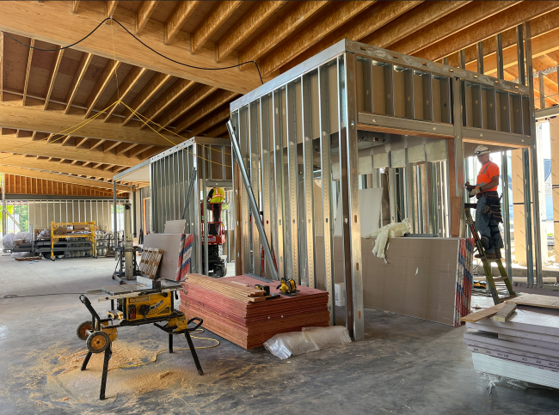 Inside the new Westonka Library build this image shows two rooms being framed out with steel and the wood beams high above.
