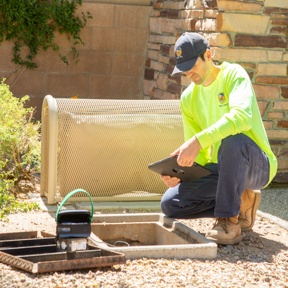 Guy checking water meter.