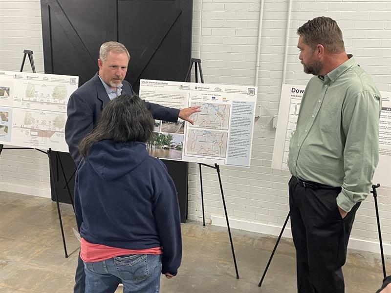 Project staff talk to a resident about storm water outfalls.