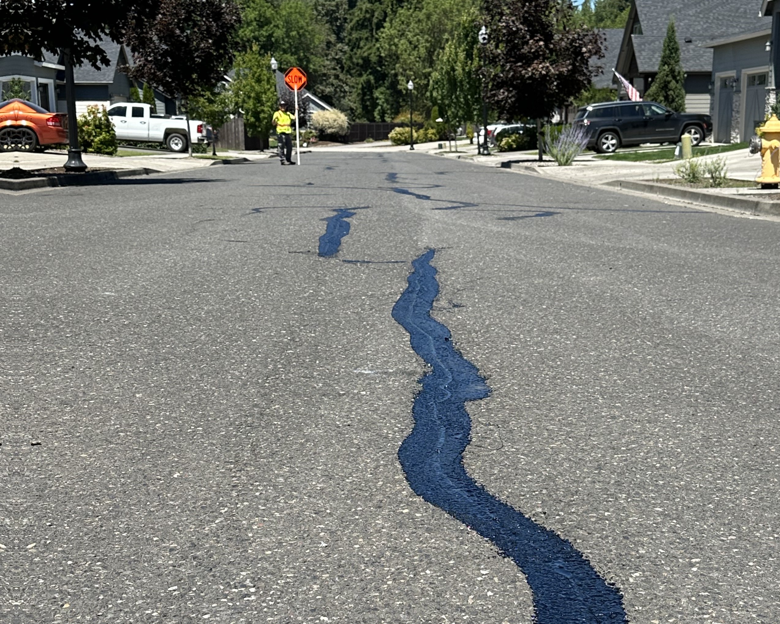 Crack seal lines on a neighborhood road.