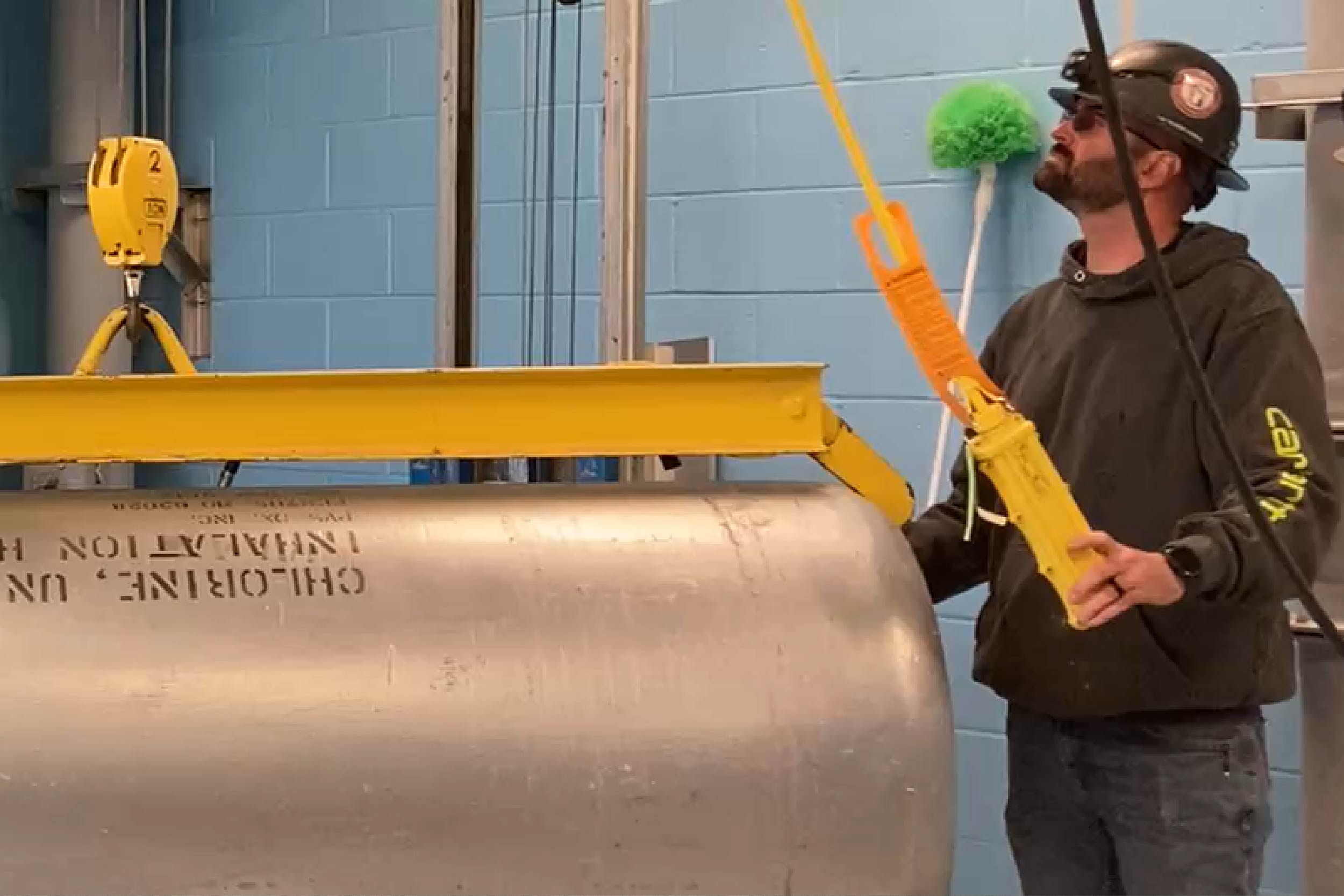 City of Columbia's Brennen Turner runs a test -- with an empty tank -- of the jib crane on the monorail in the chlorine storage room of the new Chemical Building.