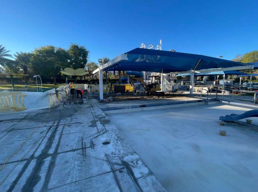 Image of construction team working on pool deck. 