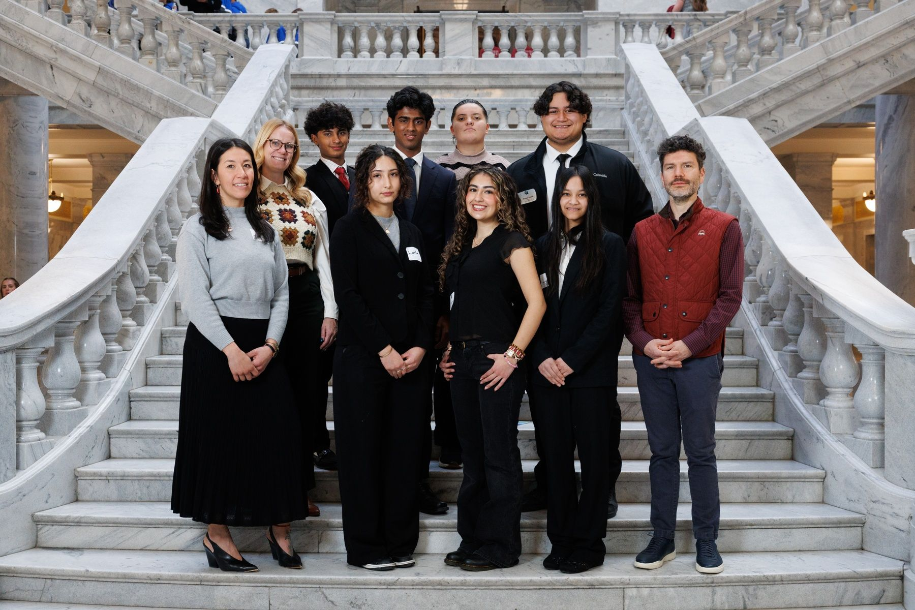 People standing on elaborate marble stairway