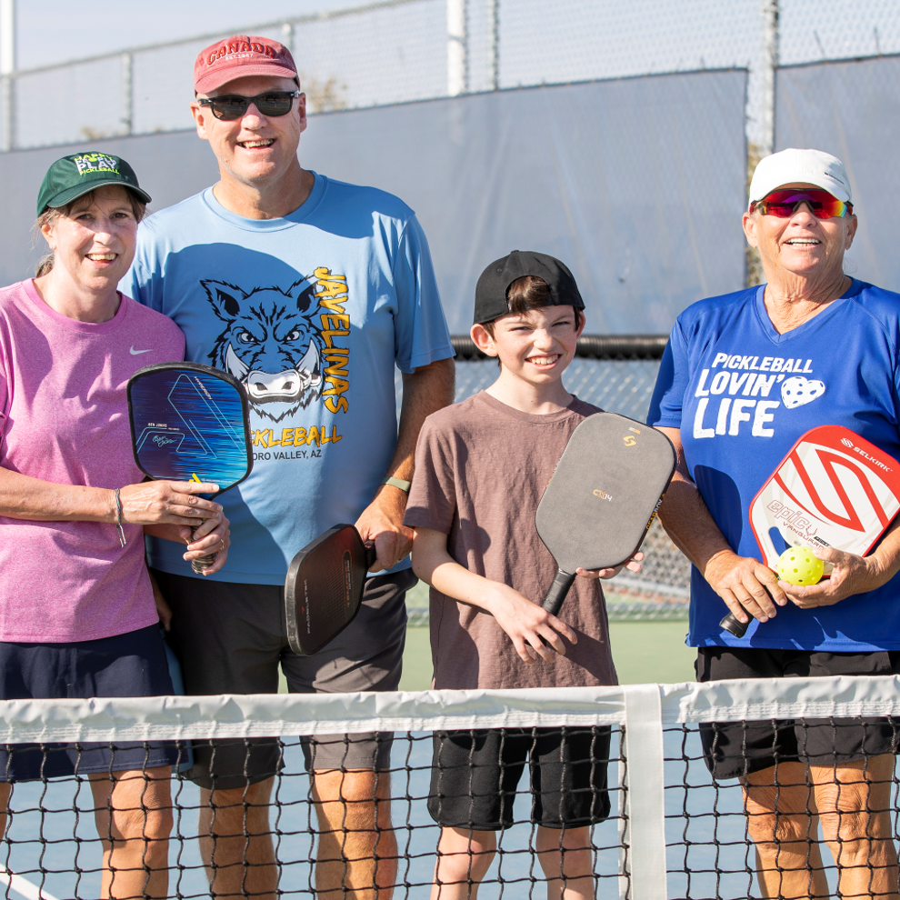 Family playing pickleball