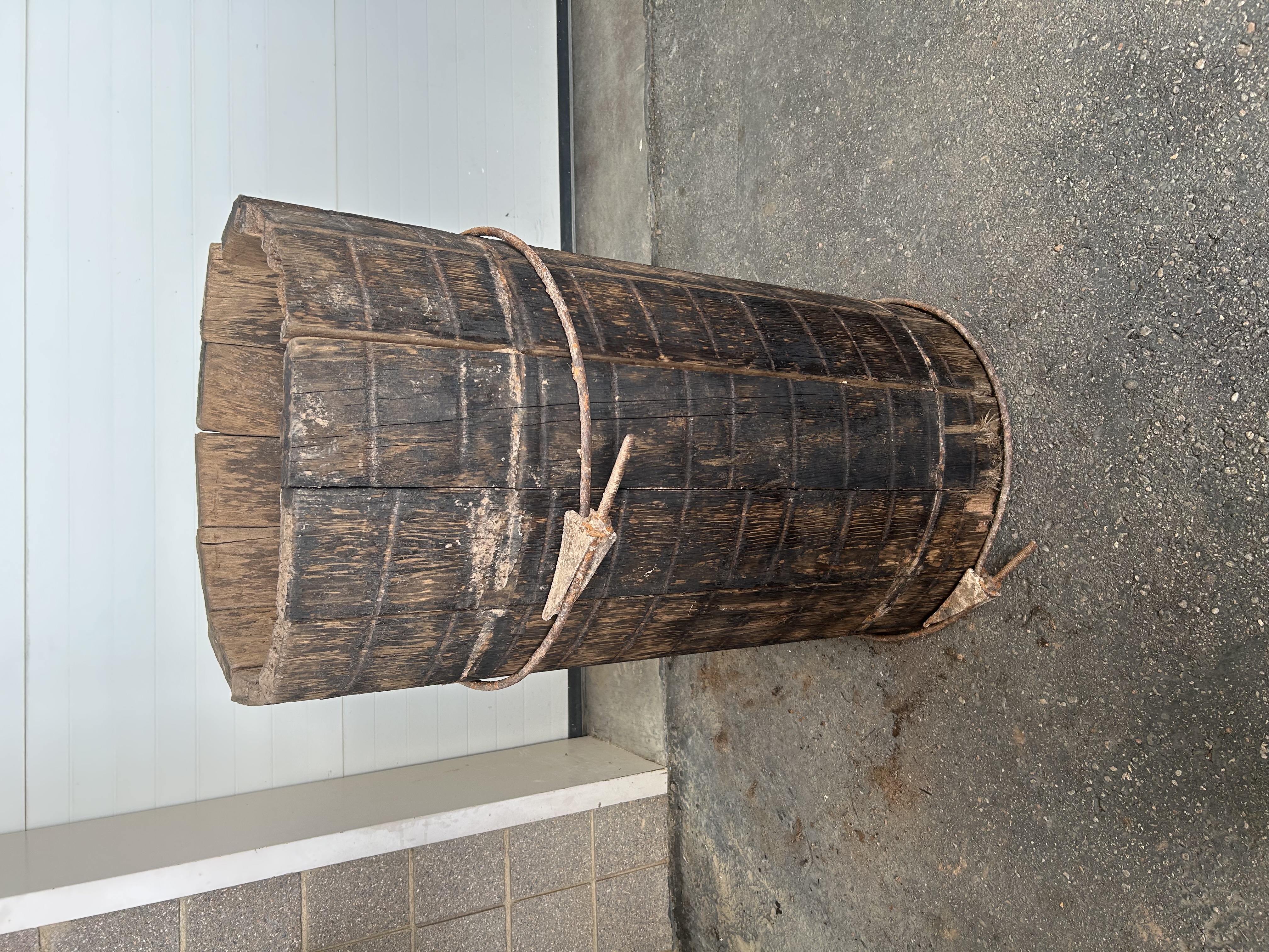 A cylindrical wooden structure around 4ft high. 