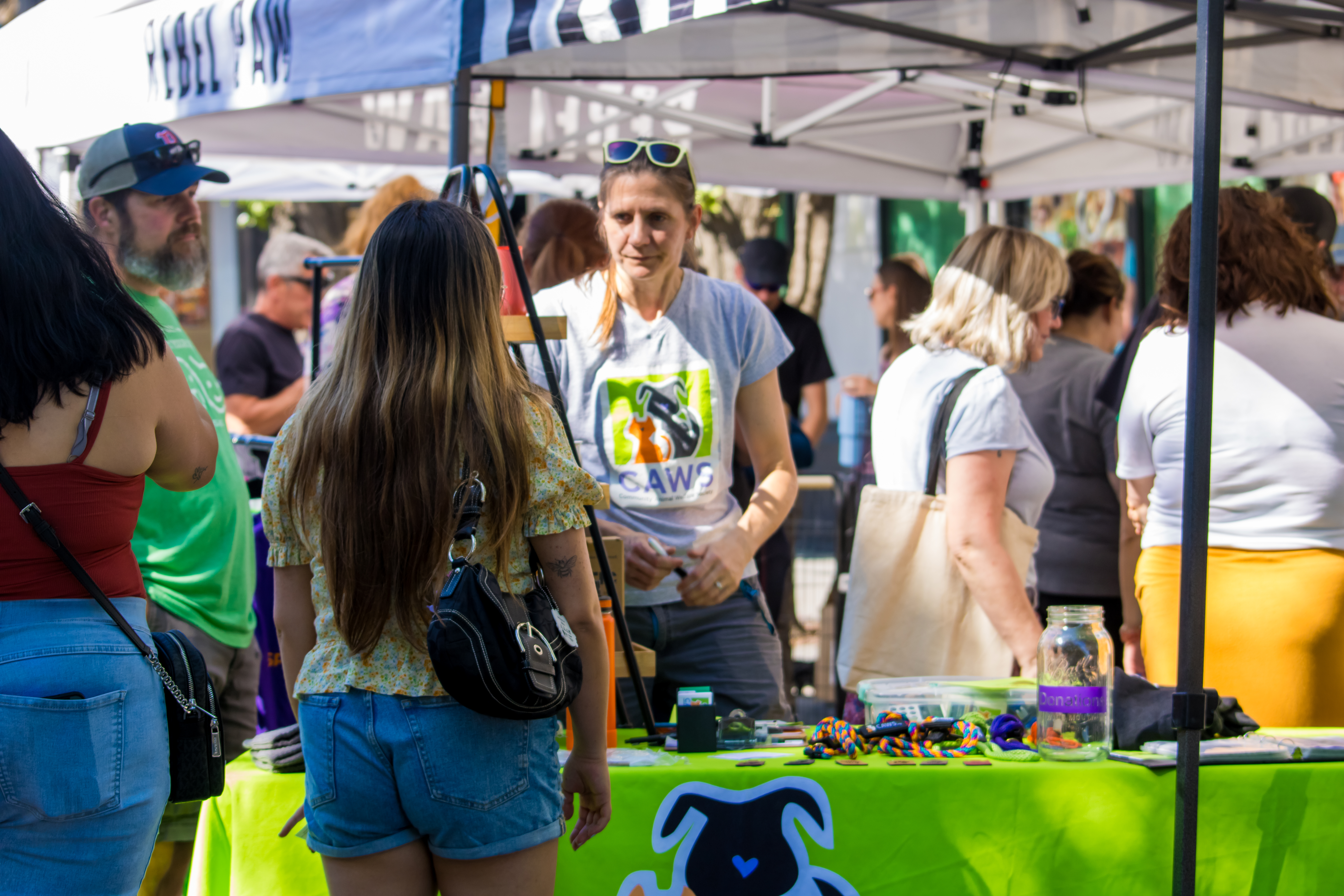 Rebel Paws booth with people