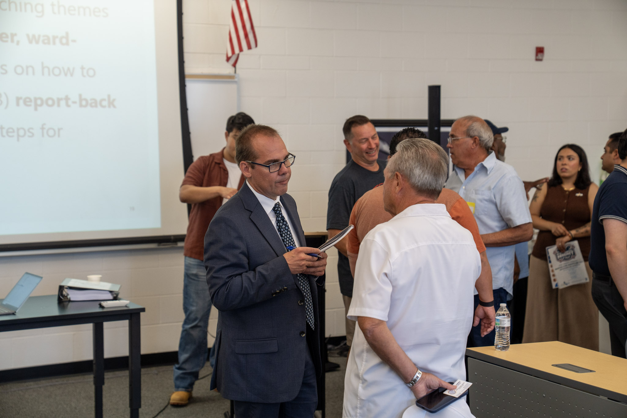 60th Mayor of Aurora John Laesch engaging with citizen at town hall, 2025.