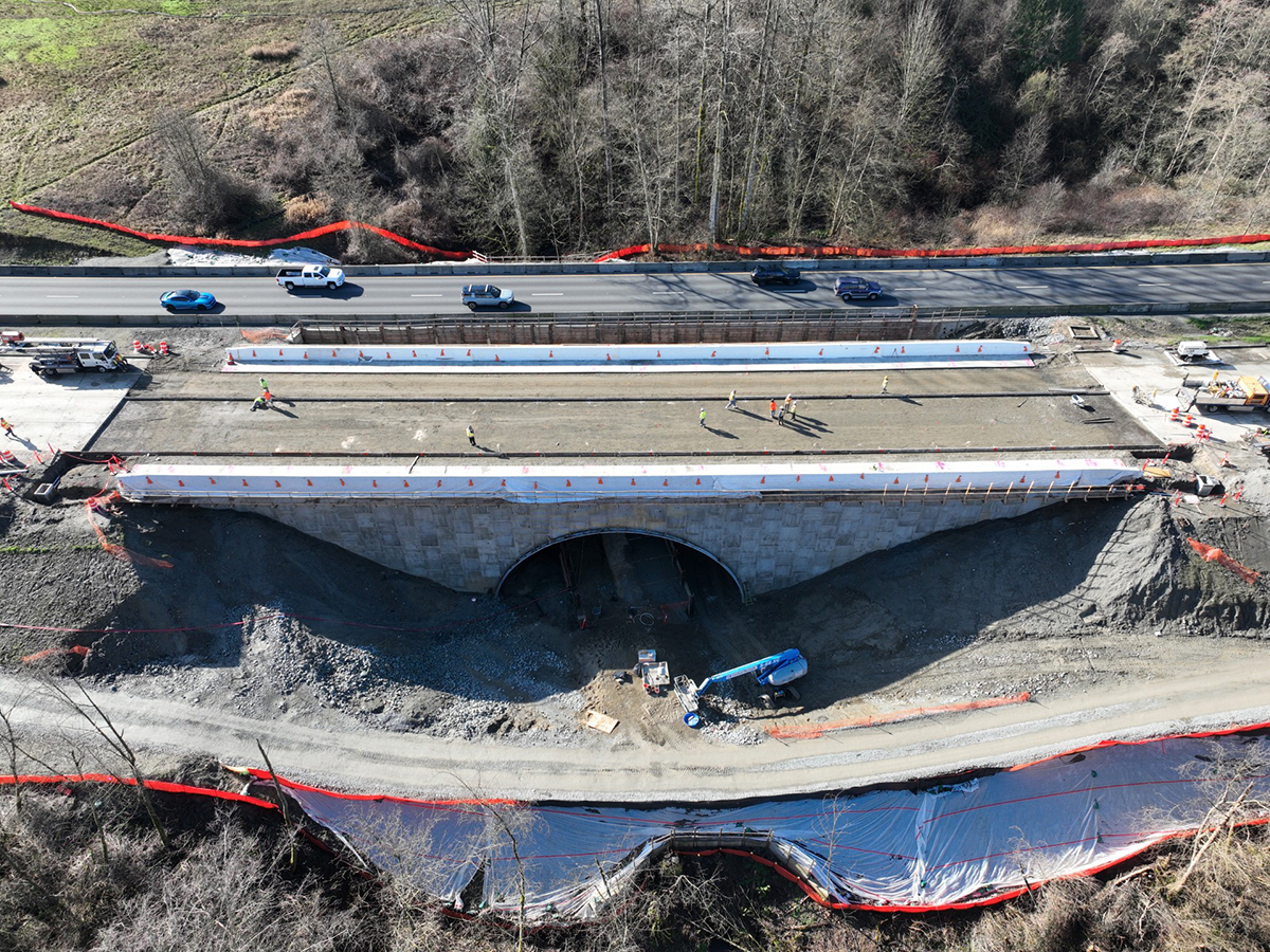 I‑5 Secret Creek northbound construction site with crews building a new bridge over a forested hillside.