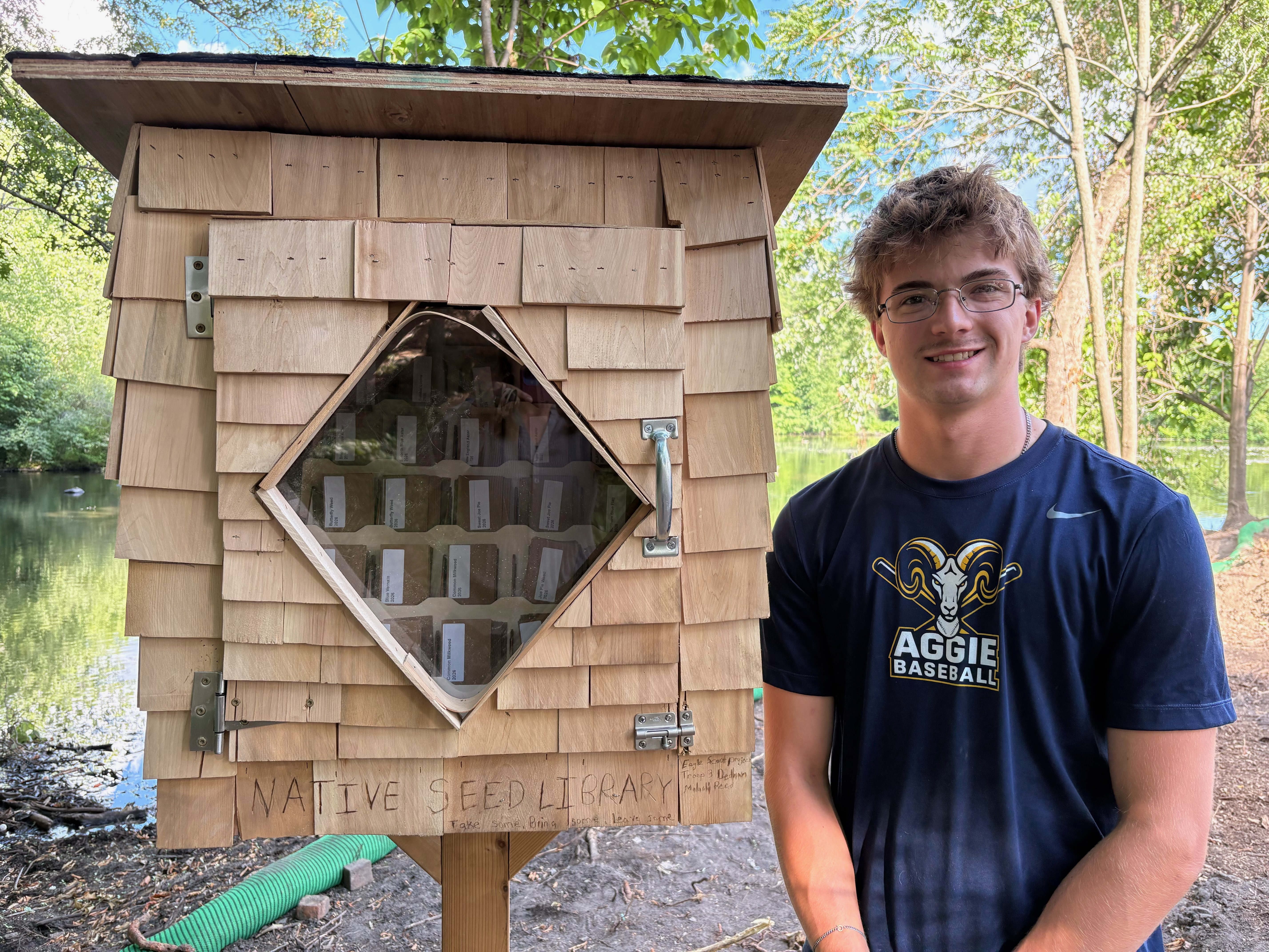 Eagle Scout candidate Malachi Reed poses with his finished project - a native seed library filled with seeds for the communities' use. 