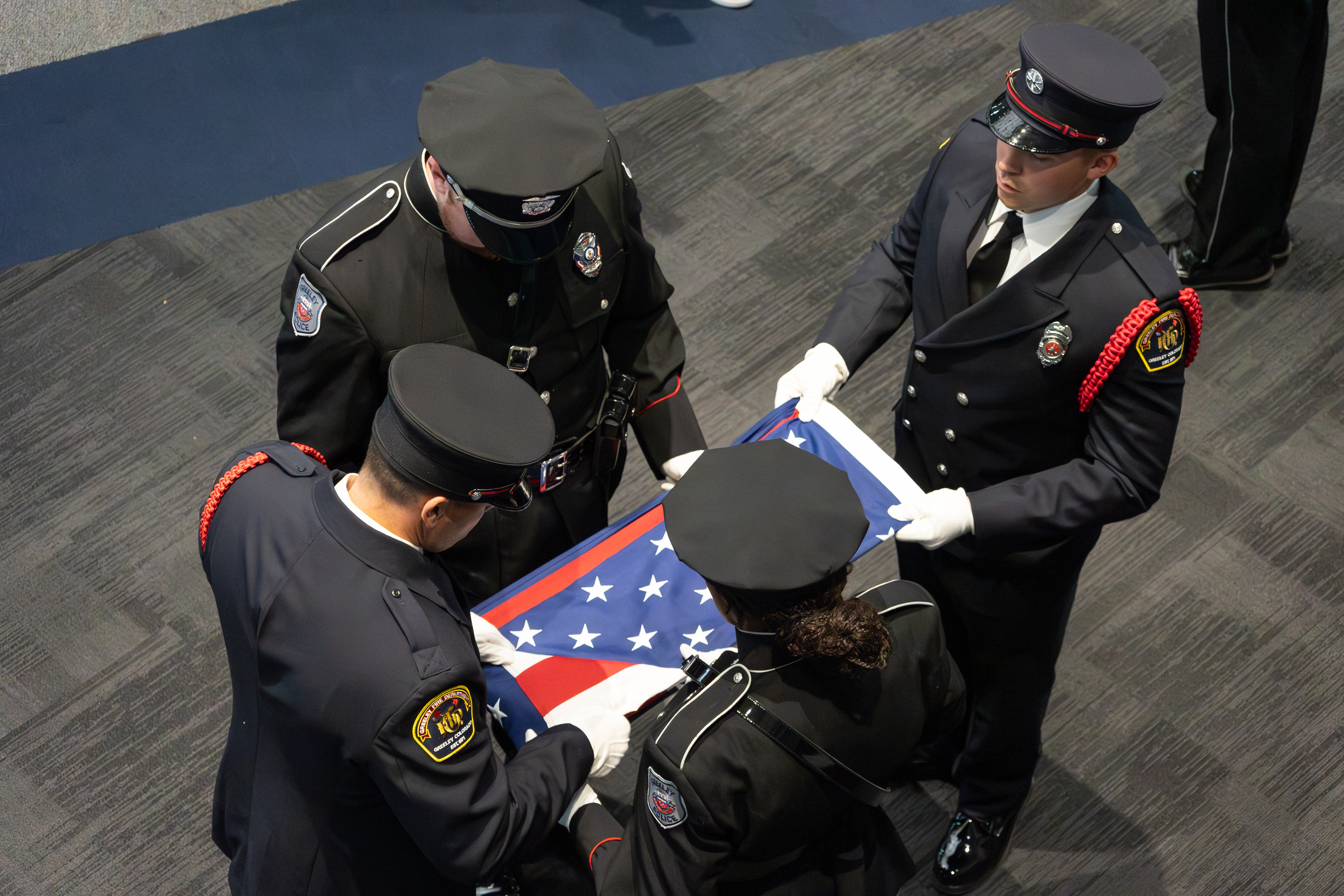 Honor guard folding the American flag during the flag retirement ceremony.