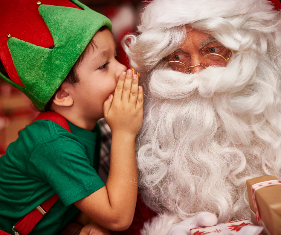 Child whispers in Santas Ear