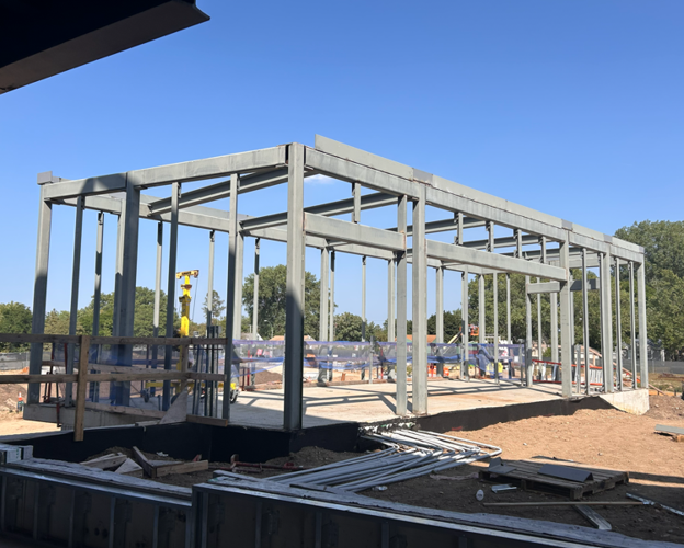Steel rectangular framed structure with openings on one side. Will be future home of Edina Art Center kilns.