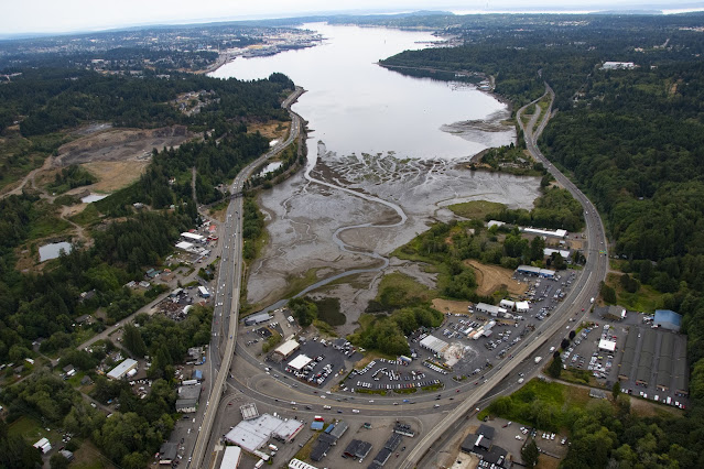Photo of the intersection of State Route 3 and State Route 16. The two highways run along either side of Sinclair Inlet and converge in Gorst at the base of Sinclair Inlet.