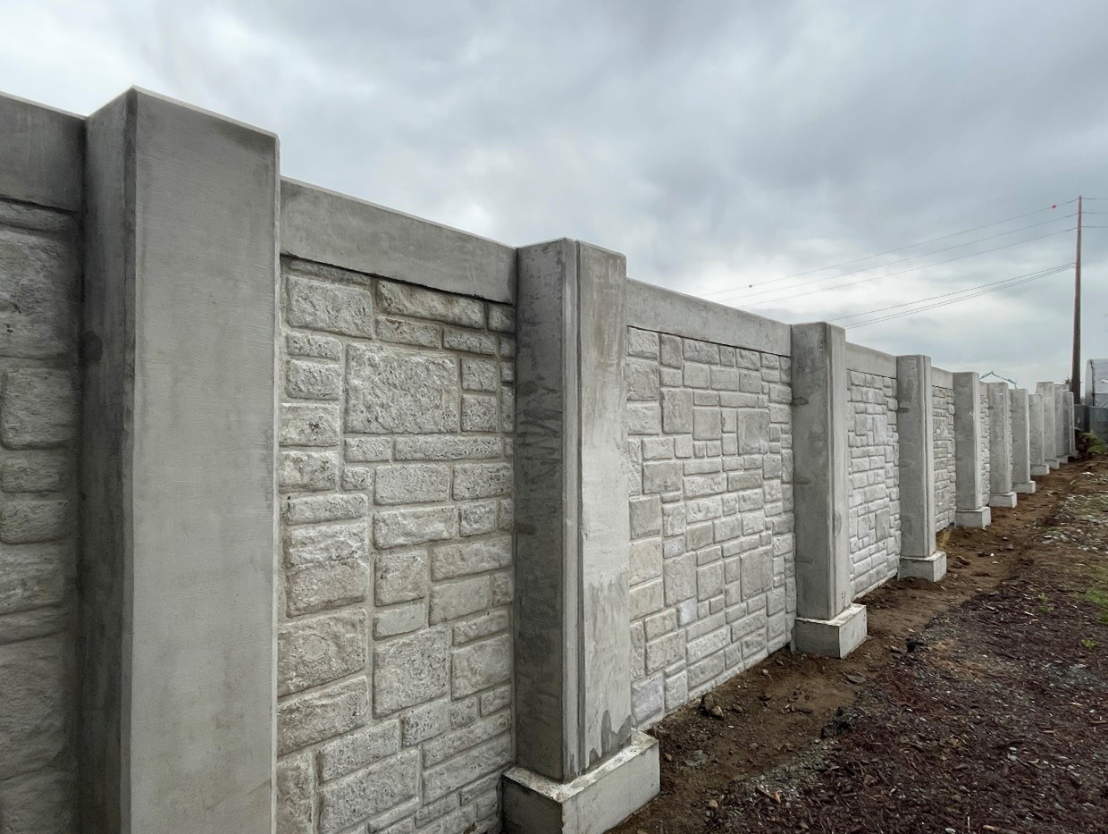 A large grey completed noise wall. 