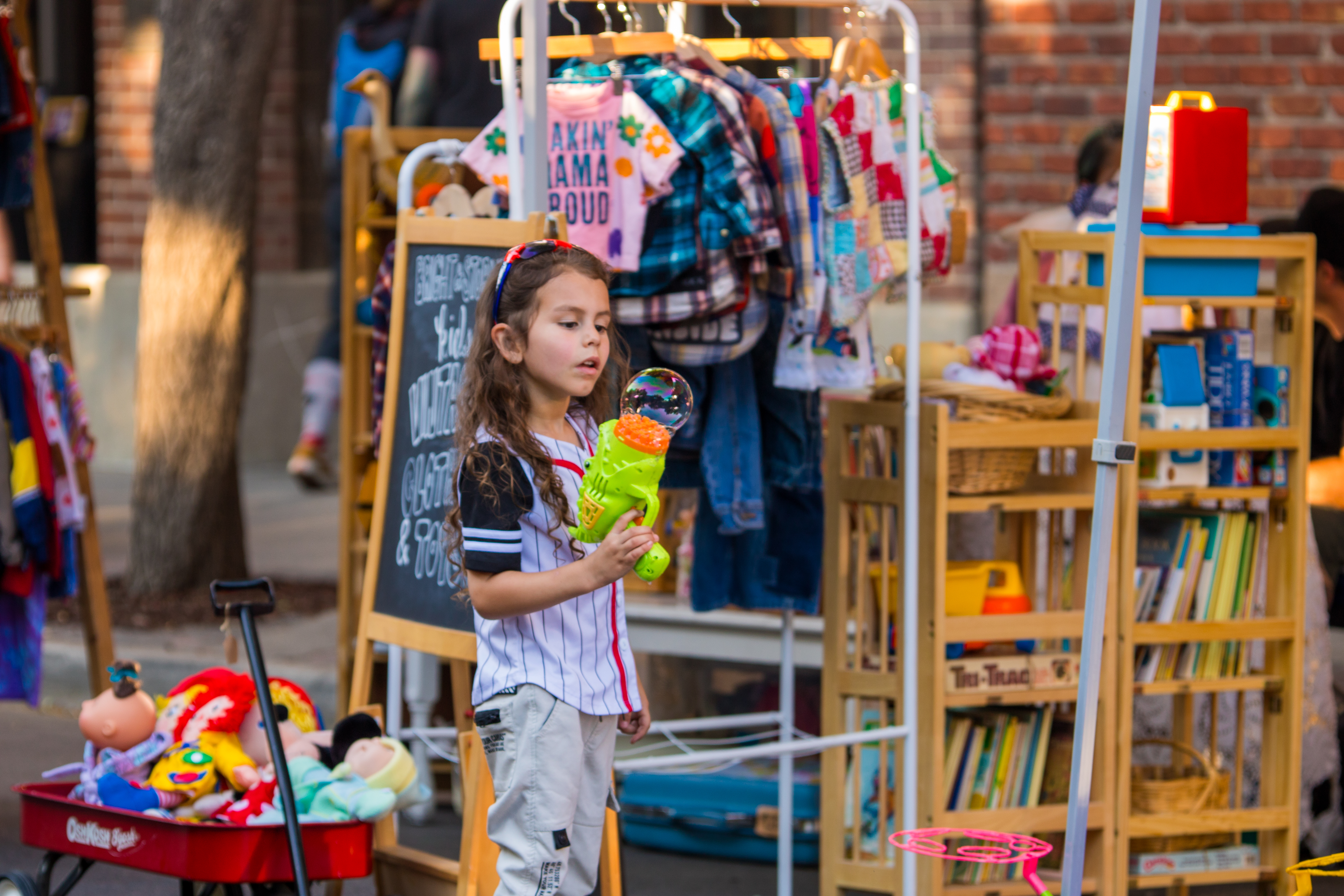 Girl with toy at outdoor market