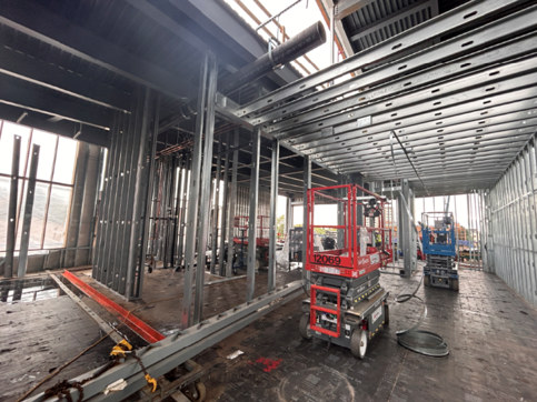Image shows interior room framing on left side of photo and ceiling framing at top of photo