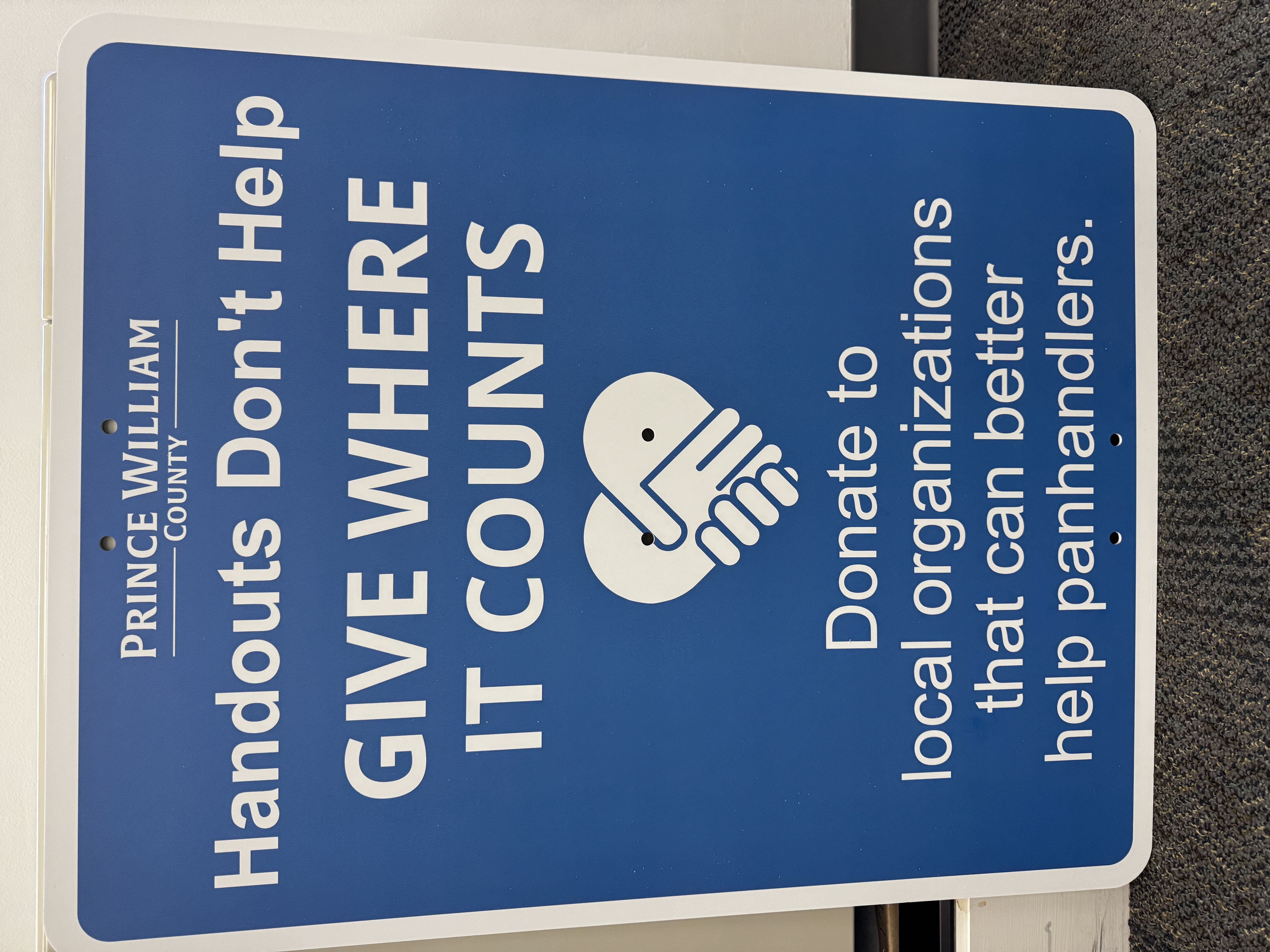 Handouts Don't Help Give Where It Counts sign