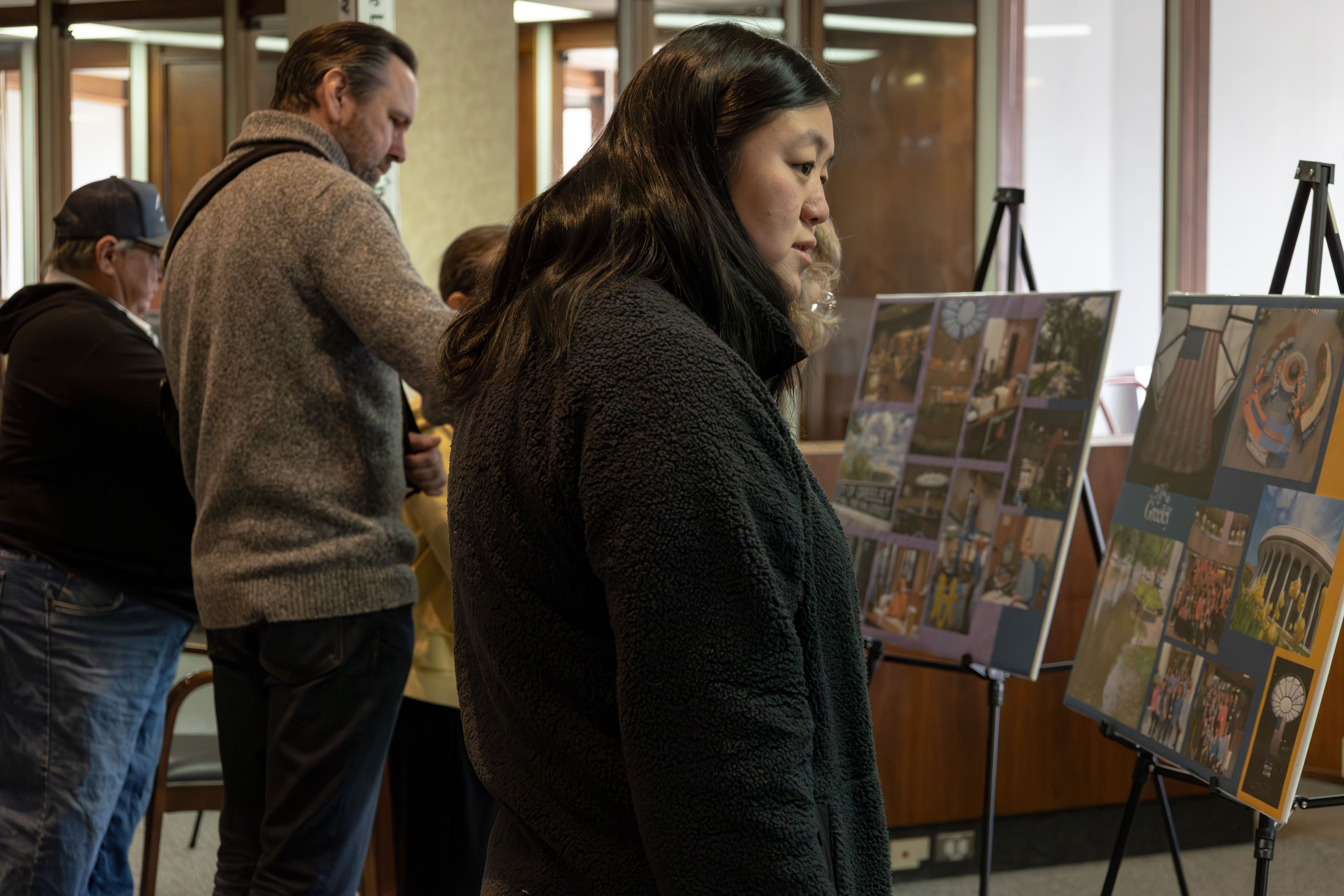Attendees view boards with images of the Round Building throughout the years.