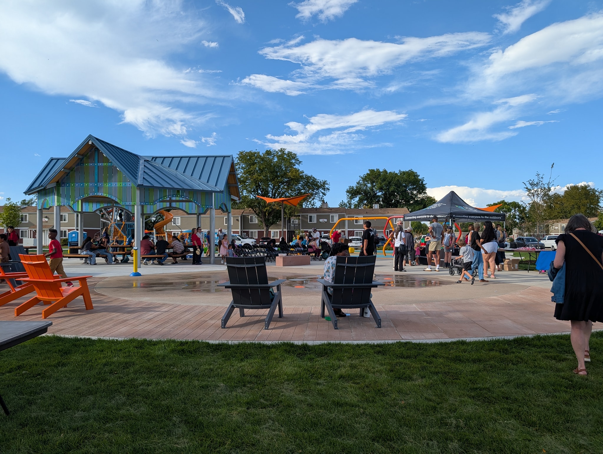 Delta Park with a gazebo, spash pad, playground and lots of people.