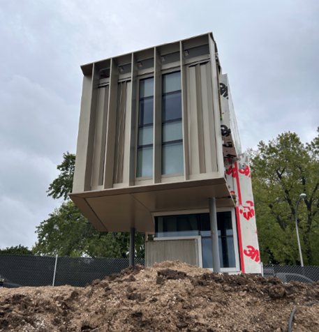 Image shows construction mockup that includes two small scale building stories using the same materials that are being used in the full scale building. This is done for testing purposes.