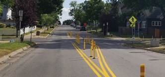 A line of yellow posts that create a median island.