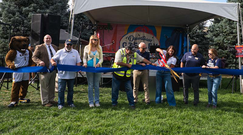 Mayor Pro Tem, Melissa McDonald and community partners cut a blue ribbon during the 16th Street Enhancement Project celebration and UNC Bear Bash.