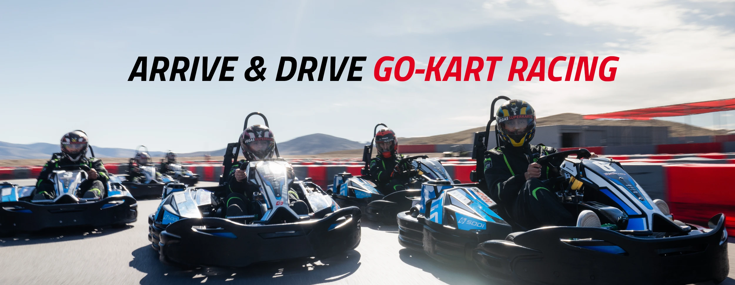Five people in helmets and racing suits drive go-karts on an outdoor track. Text above reads, "Arrive & Drive Go-Kart Racing." Energetic scene.