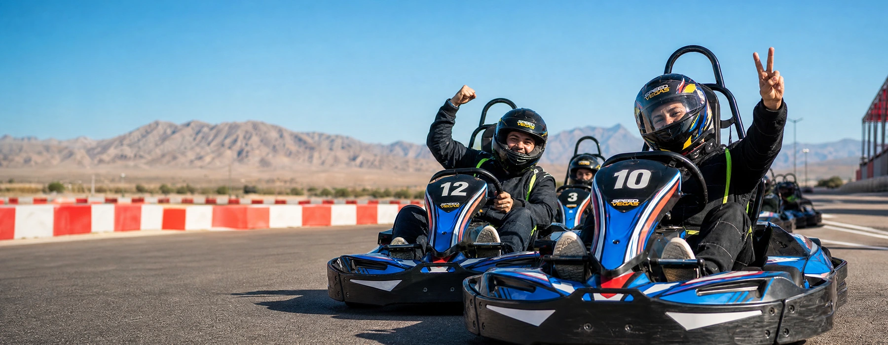 Two drivers celebrating in Sodikart go-karts at Vegas Superkarts