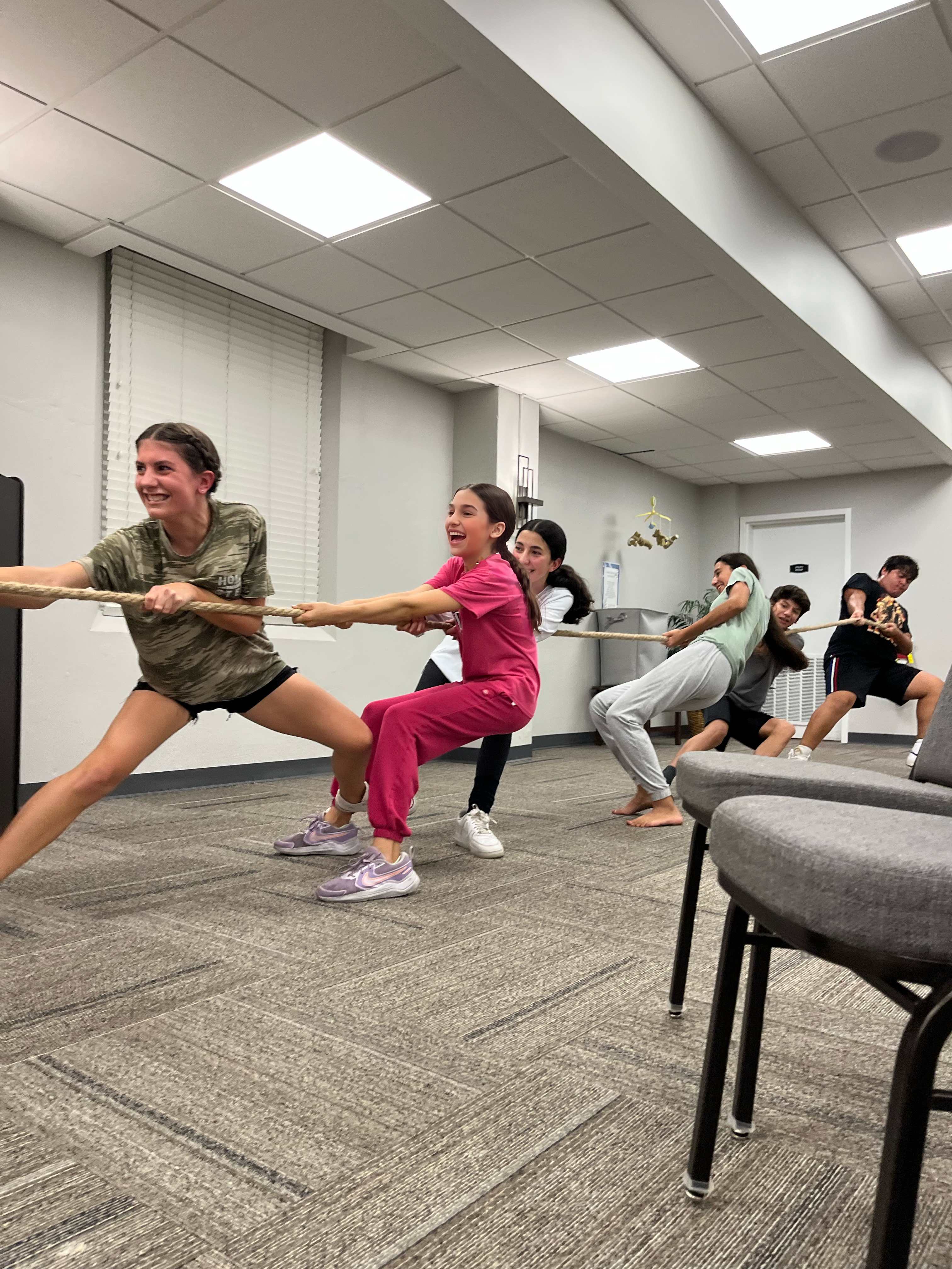 Teens playing tug of war together