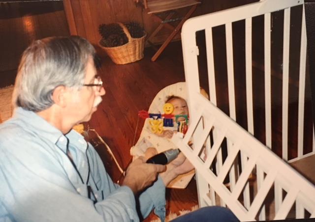Putting together portacrib, Joshua supervising in background, August 1993