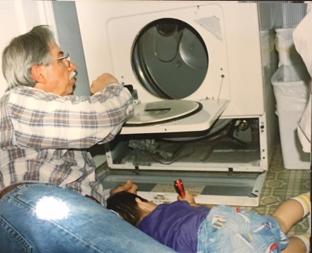 Men at work after Nathan thought the open dryer door a perfect little seat. Broken spring, 1997